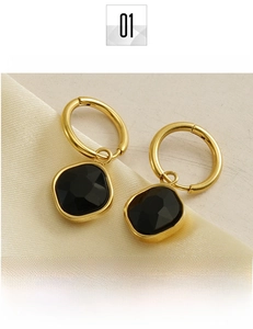 Detail of 18K gold-plated titanium earrings with black geometric zircon pendant