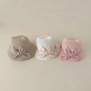 Close-up of woven baby sun hats with cute cat ears and bow detail in three colors
