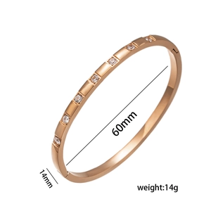 Polished rose gold open cuff bracelet with zircon inlays and 60mm diameter dimensions