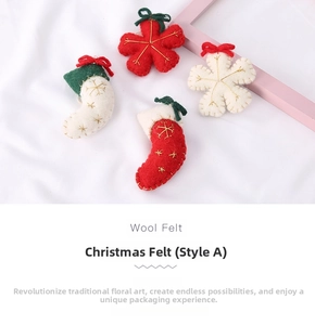 Macro detail of handmade wool felt Christmas ornaments with embroidery and bows