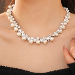 Close-up of elegant pearl necklace with diamond accents on a model neck