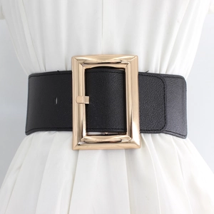 Vintage wide black elastic waist belt with large gold buckle on white pleated dress