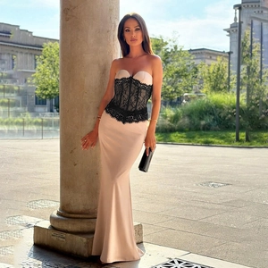 Detail of the champagne satin skirt with black lace splicing and slim-fit waistline