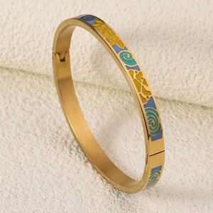 Macro detail of 18K gold plated bangle with colorful enamel abstract swirl patterns