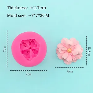 Pink food-grade silicone flower mold for fondant cake decorating on blue background