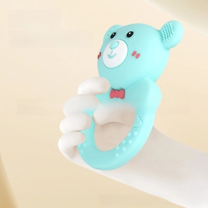 Close-up of baby silicone teether with textured blue bear and anti-slip biting points