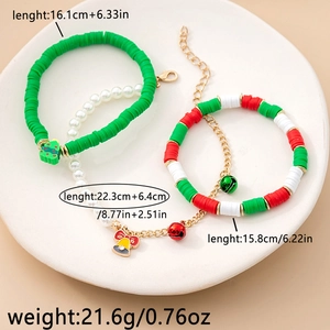Detailed view of three Christmas beaded bracelets with reindeer and bells charms