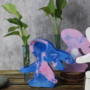 Detail of rabbit shaped resin hydroponic flower vase with marble texture and glass test tube