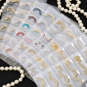 Detailed set of assorted rhinestone and pearl nail art chains in multiple color finishes