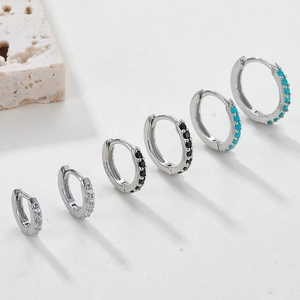 Macro shot of S925 sterling silver hoop earrings with clear black and turquoise stones