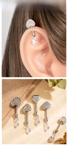 Detail view of heart stud earrings with cubic zirconia drops and micro-paved crystals