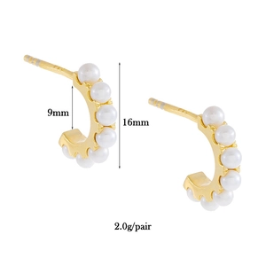 Macro view of C-shaped 18K gold earrings with pearls showing 9mm inner diameter size