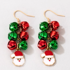 Detailed view of Christmas earrings with red and green bells and Santa Claus charms