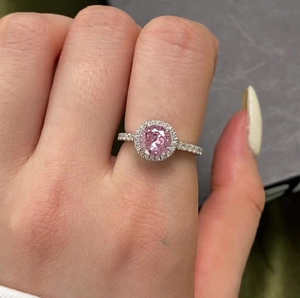Close-up of S925 silver ring featuring a round pink zircon in a classic halo setting