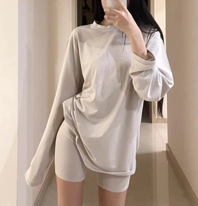 Mirror selfie showing the oversized beige long-sleeve T-shirt and matching biker shorts set