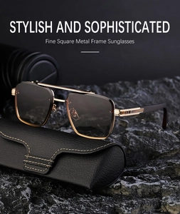 Close-up of rimless square sunglasses with gold metal frame and brown gradient lenses
