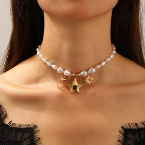 Choker necklace featuring irregular white pearls and gold star pendants with blue gems
