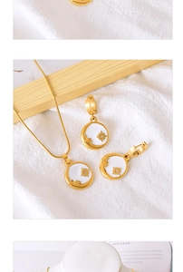Detailed macro view of gold snake chain necklaces and sun moon enamel charms