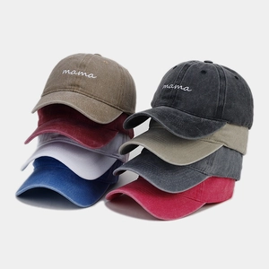 Detailed pile of vintage washed cotton baseball caps in various colors with mama embroidery