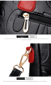 Detail of black lychee grain leather handbag with gold hardware and red leather accents