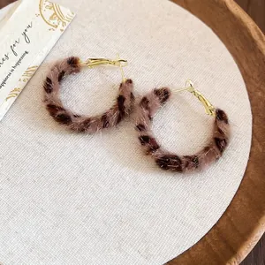 Minimalist round leopard print faux fur hoop earrings with gold-toned metal closure
