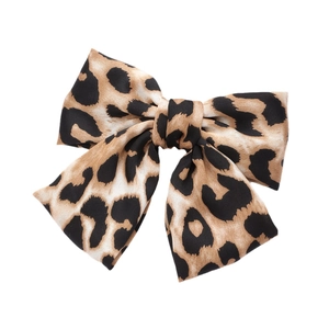 Elegant leopard print bow hair clip made of satin fabric for a stylish hair accessory