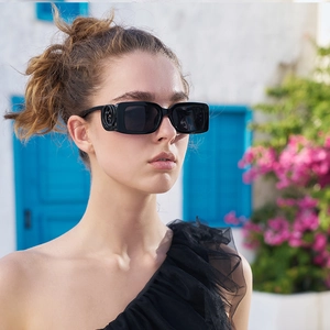Fashion rectangular sunglasses with gold-tone logo hinge detail worn by a model