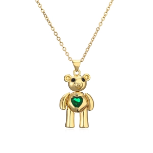 Gold bear pendant necklace with green heart-shaped gemstone on a clean white background