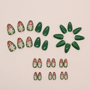 Detail of Christmas press-on nails with green finish and festive red bow wreath art