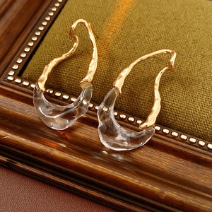 Macro shot of 18k gold plated teardrop earrings with fluid metal and transparent resin detail