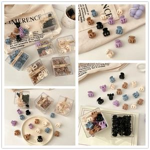Detailed view of matte mini hair claws in various colors inside a handmade gift box