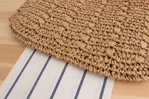 Macro view of woven paper rope texture on a square crossbody bag for summer style