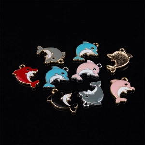 Macro shot of colorful enamel dolphin pendants for DIY jewelry making in multiple colors