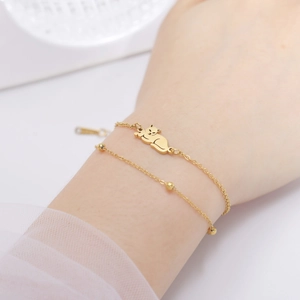 Golden double-layer stainless steel beaded bracelet featuring a cute cat pendant for women