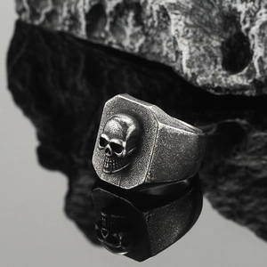 Macro side view of vintage skull signet ring in aged steel with sharp carving details