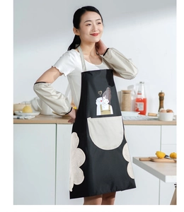 Detail of waterproof apron with absorbent side towels and girl print with beige oversleeves