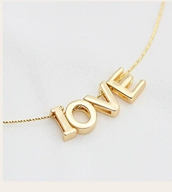 Detailed view of a gold 14k plated box chain necklace featuring a LOVE letter pendant
