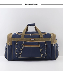 Front detail of navy blue canvas travel bag featuring multi-pocket design and khaki handles