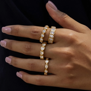 Detailed view of 18K gold stainless steel rings with sparkling cubic zirconia on hand
