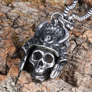 Macro detail of silver biker skull pendant with samurai helmet on rustic bark background