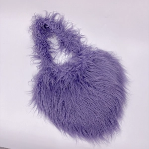 Detailed close-up of purple faux fur heart bag showing high-quality long plush texture