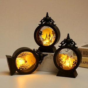 Three Halloween LED lanterns with black castle and witch silhouettes in warm yellow light