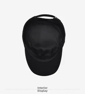 Detail view of the breathable mesh lining and interior stitching of the black flat top hat