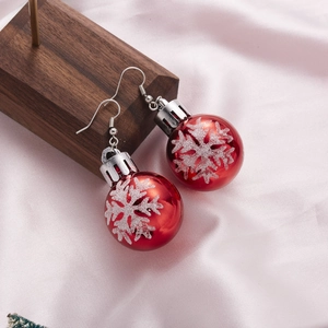 Christmas ball earrings featuring silver snowflakes on red spheres with festive hooks