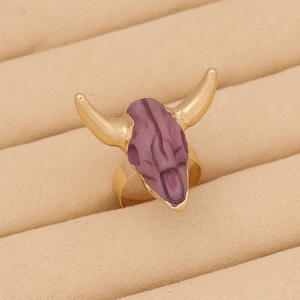 Bohemian bull skull ring in gold and purple finish, vintage jewelry shown in a box