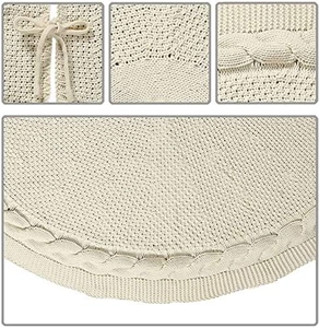 Detail of beige cable-knit Christmas tree skirt with decorative ribbon ties and texture