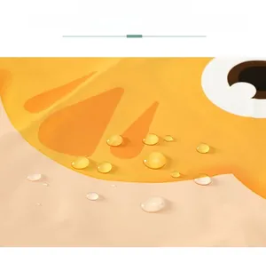Detail showing waterproof yellow fabric with cartoon animal print and water droplets