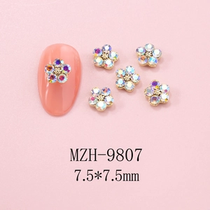 Macro view of 7.5mm flower nail rhinestones with gold base and AB iridescent crystals
