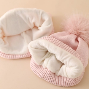 Pink knit kids winter hat with fleece lining and unicorn embroidery details