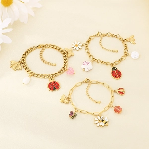 Three-piece gold charm bracelet set featuring bees, ladybugs, daisies and hearts charms